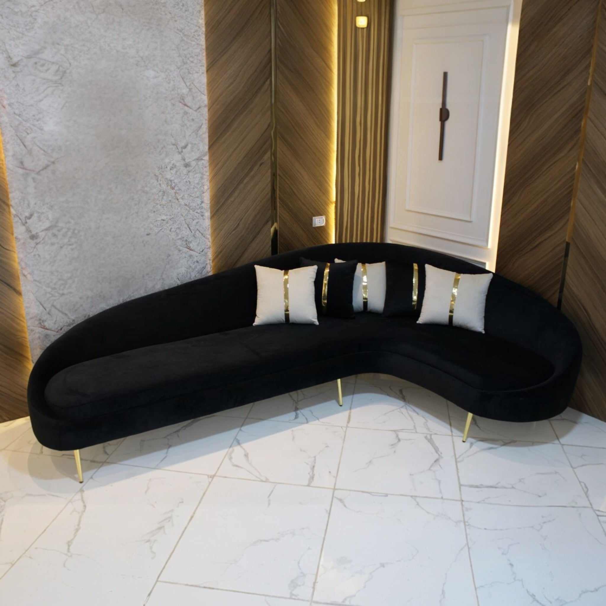 ركنة هلال - ركنة هلال الشكل والتصميم: تصميم هلالي أنيق يُضفي لمسة عصرية على أي مساحة. القاعدة مزودة بأرجل معدنية ذهبية لامعة تضيف لمسة من الفخامة. الوسائد مزينة بشرائط ذهبية تضفي جمالاً متناغماً مع التصميم العام. القماش: نوع القماش: جيرمان. يتميز بملمسه الناعم ومتانته العالية. متوفر بألوان متنوعة تناسب جميع الأذواق والديكورات. المزايا: تصميم مناسب للمساحات العصرية. مريح للاسترخاء ويُضفي لمسة راقية على الغرفة. يمكن استخدامه في غرف المعيشة أو الاستقبال. الأبعاد: الطول الكلي: 3 متر. العرض الكلي: 2 متر.