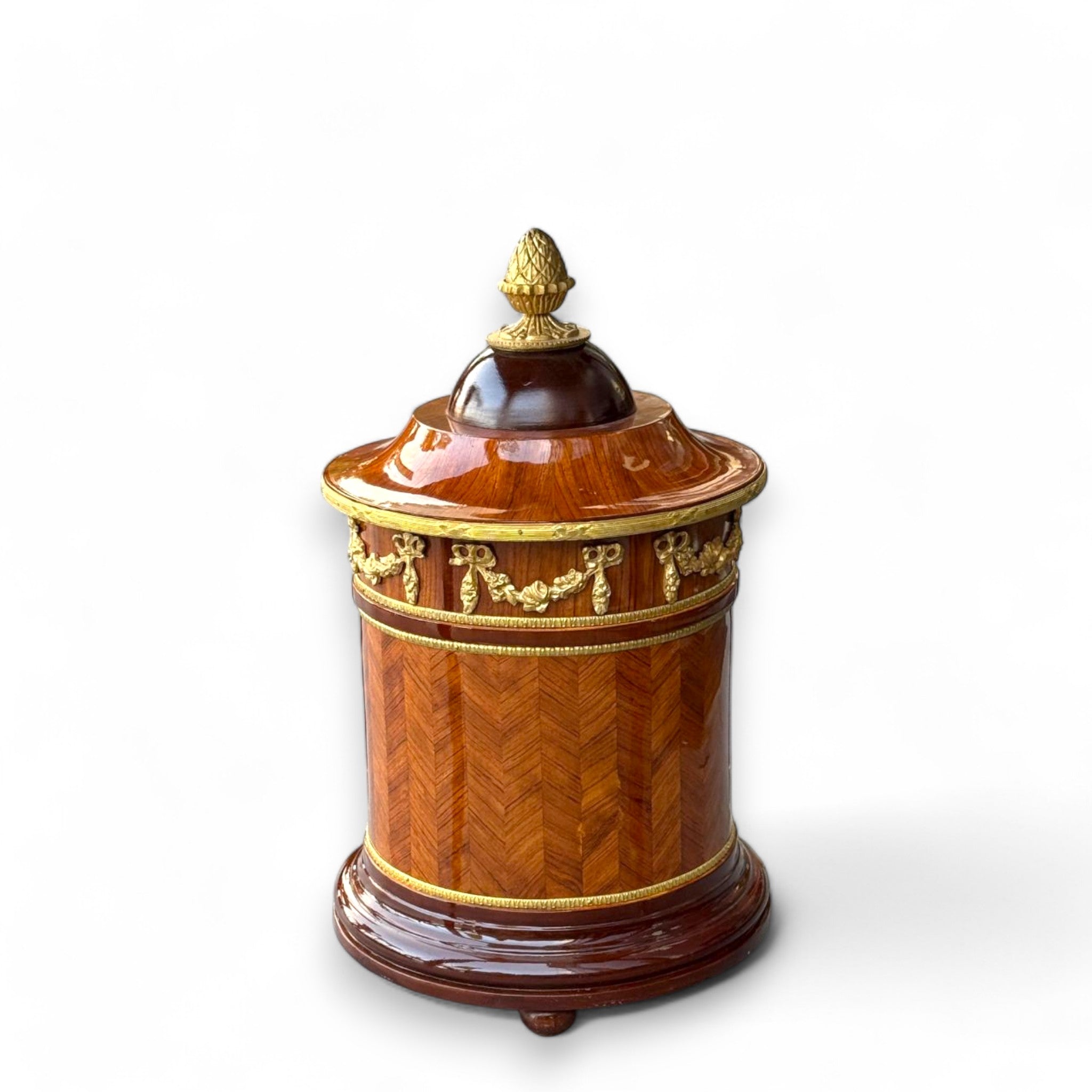 سلّة مهملات كلاسيكية فاخرة بتصميم خشبي وزخارف نحاسية - سلّة مهملات بتصميم كلاسيكي راقٍ مصنوعة من الخشب الطبيعي، مزودة بزخارف نحاسية ذهبية تضفي لمسة من الفخامة. تتميز بغطاء علوي مزخرف وأنيق، مما يجعلها مثالية للاستخدام في المكاتب، الصالونات، أو الغرف الكلاسيكية حيث تجمع بين العملية والجمال. الارتفاع: 50 سم القطر: 30 سم